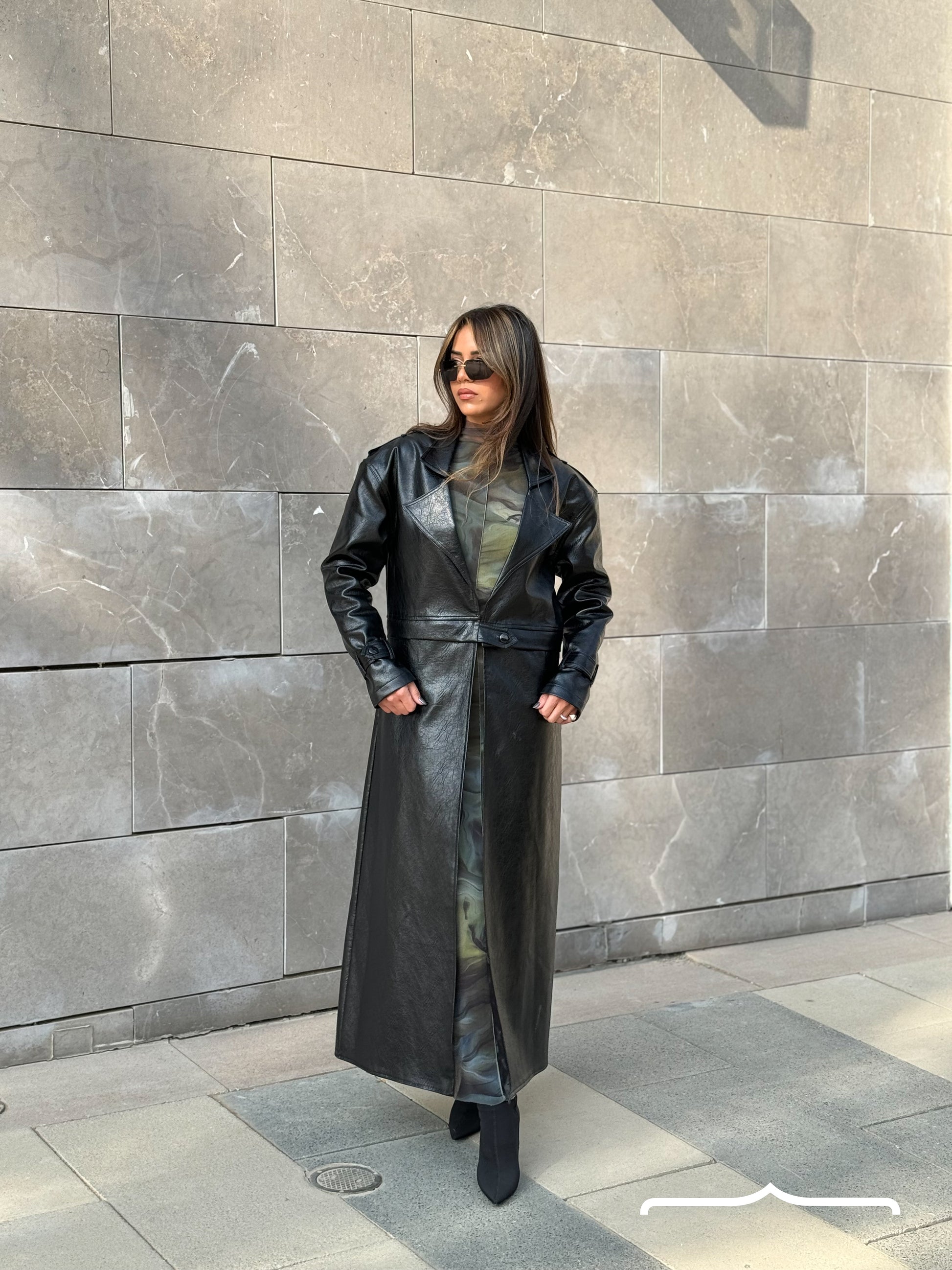 a woman model wearing a leather coat 